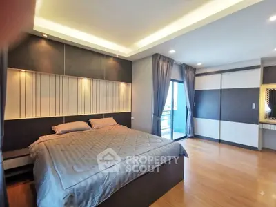 Spacious modern bedroom with elegant design and large windows offering natural light.
