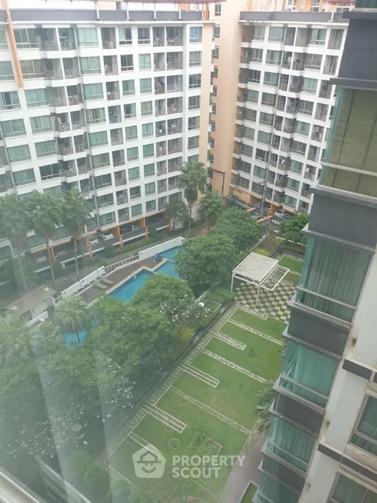 Stunning high-rise apartment view with lush garden and pool amenities