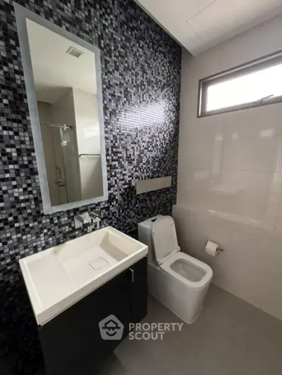 Modern bathroom with sleek design and mosaic tile wall