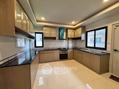 Spacious modern kitchen with sleek cabinetry and gas stove