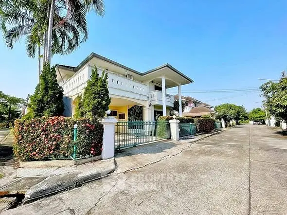 Stunning two-story house with lush garden and spacious driveway in serene neighborhood.