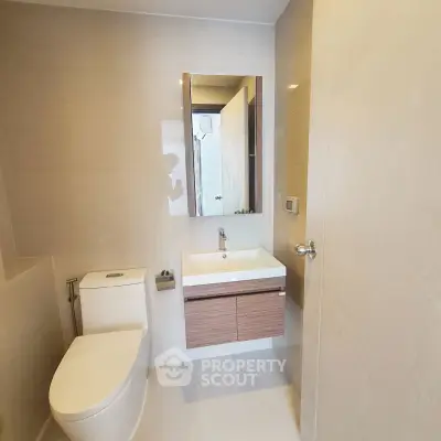 Modern bathroom with sleek fixtures and minimalist design in a contemporary apartment.