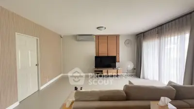 Spacious living room with modern decor and large windows for natural light.