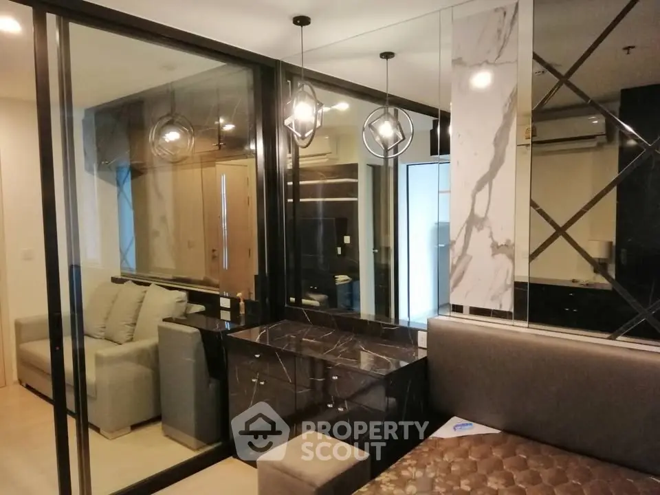 Modern living room with stylish decor and glass partitions in a luxury apartment.