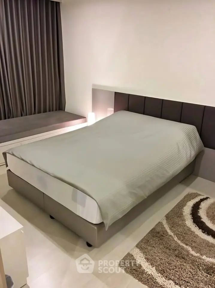 Modern bedroom with cozy bed and stylish decor in a contemporary apartment.
