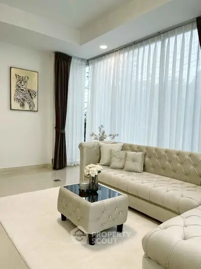 Elegant living room with plush beige sofa and chic decor