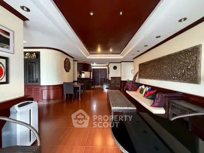 Spacious living room with elegant wooden decor and modern furnishings