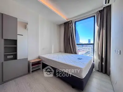 Modern bedroom with large window offering stunning city view, minimalist design, and ample natural light.