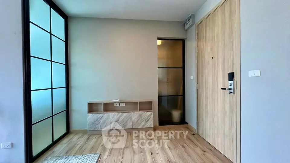 Modern apartment entrance with sleek wooden flooring and stylish storage unit