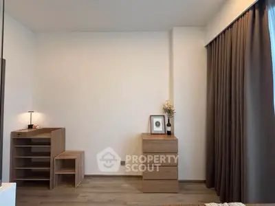Minimalist bedroom with wooden furniture and floor-to-ceiling curtains, perfect for modern living.