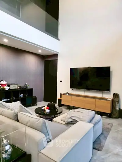 Modern living room with high ceiling and sleek furniture design