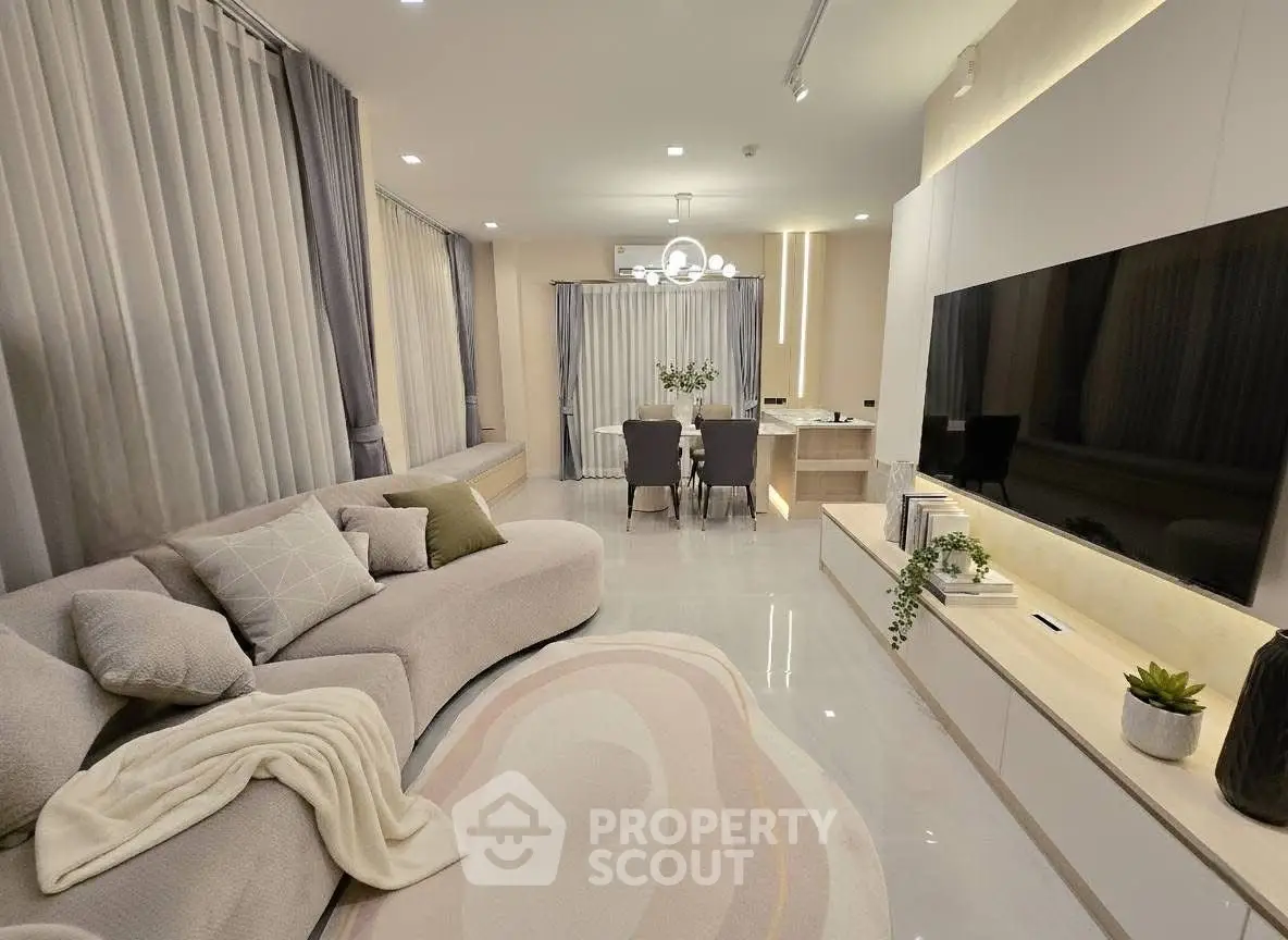Luxurious modern living room with elegant decor and spacious dining area, perfect for stylish urban living.