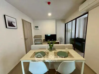 Modern dining area with elegant table setting in a cozy apartment interior.