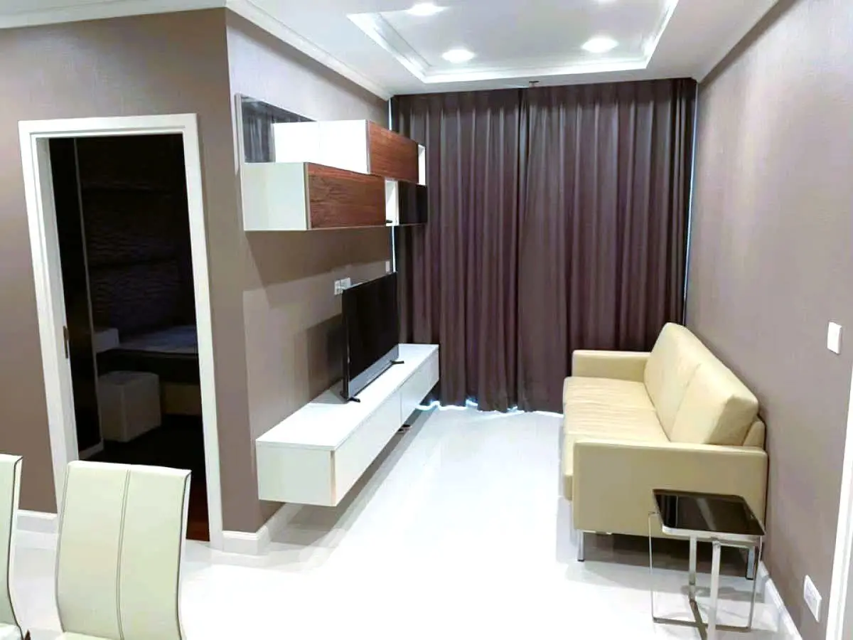 Modern living room with sleek furniture and wall-mounted TV in a stylish apartment.