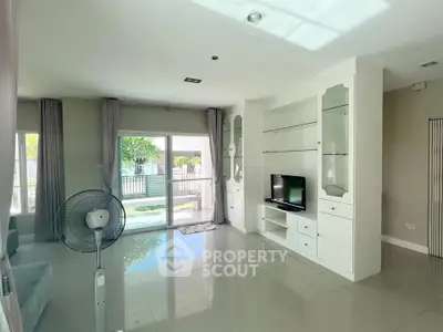 Spacious living room with modern decor and large windows for natural light.