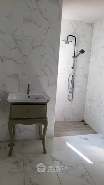 Elegant bathroom with marble tiles and modern shower design