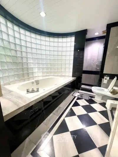 Luxurious bathroom with modern design and elegant bathtub in upscale property.