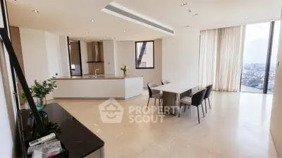 Luxurious open-plan living and dining area with panoramic city views, modern kitchen, and elegant decor.
