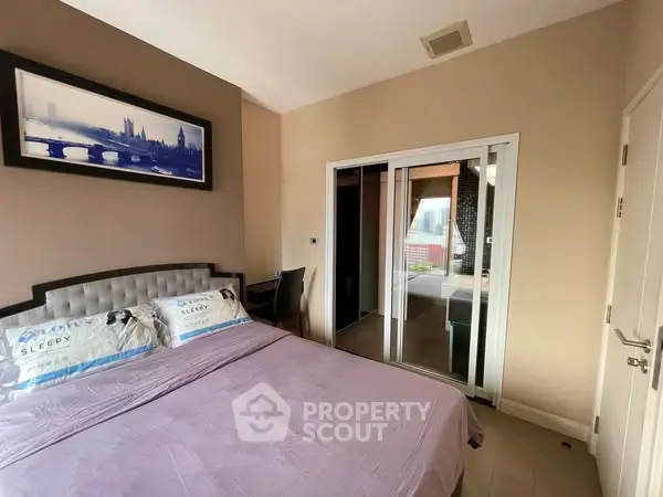 Cozy bedroom with modern decor and ensuite bathroom, perfect for relaxation.