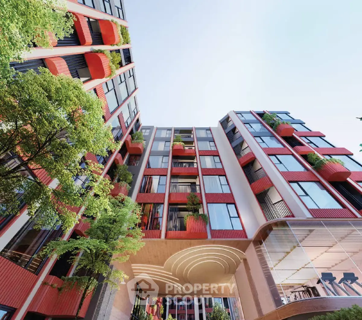 Modern architectural building with vibrant red facade and lush greenery