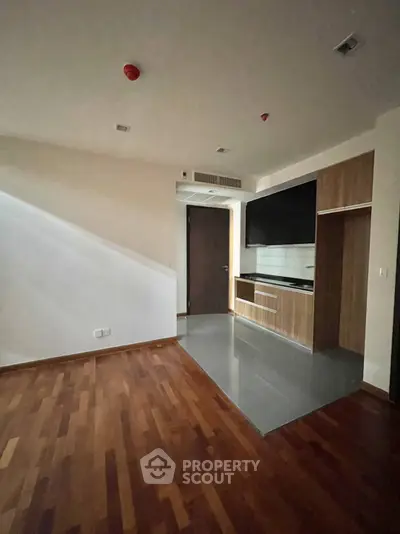 Modern kitchen with sleek wooden flooring and open layout design