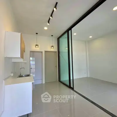 Modern minimalist kitchen with sleek design and open layout in a bright apartment.
