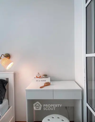 Cozy bedroom corner with modern white desk and warm lighting