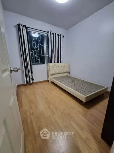 Cozy bedroom with wooden flooring and minimalist decor