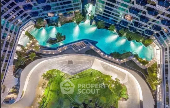 Stunning aerial view of modern residential complex with unique architecture and luxurious pool area.