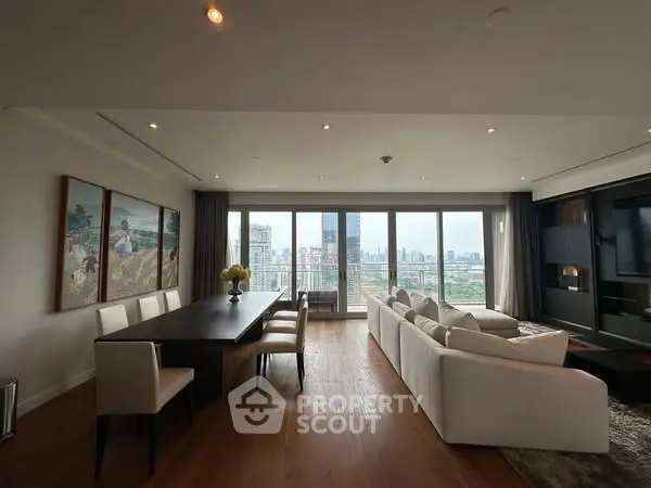 Spacious living room with panoramic city view and elegant dining area.
