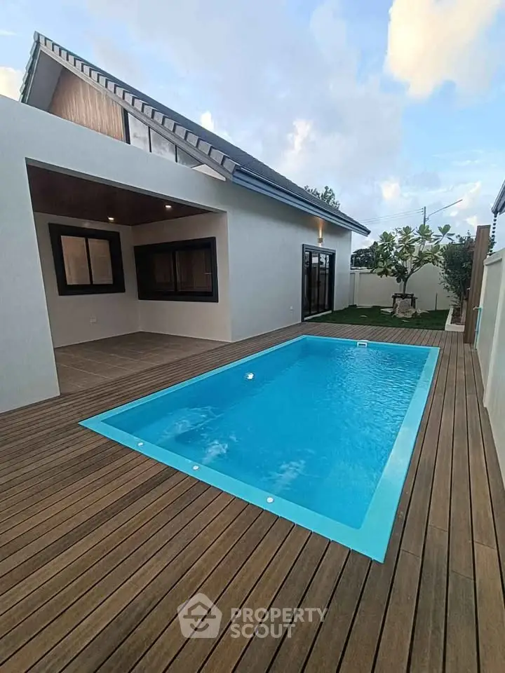 Modern house with private pool and wooden deck, perfect for luxury living.