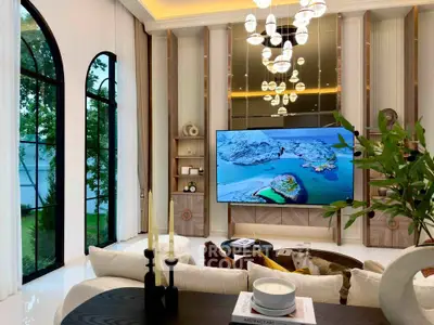 Luxurious living room with high ceilings, large windows, and elegant chandelier