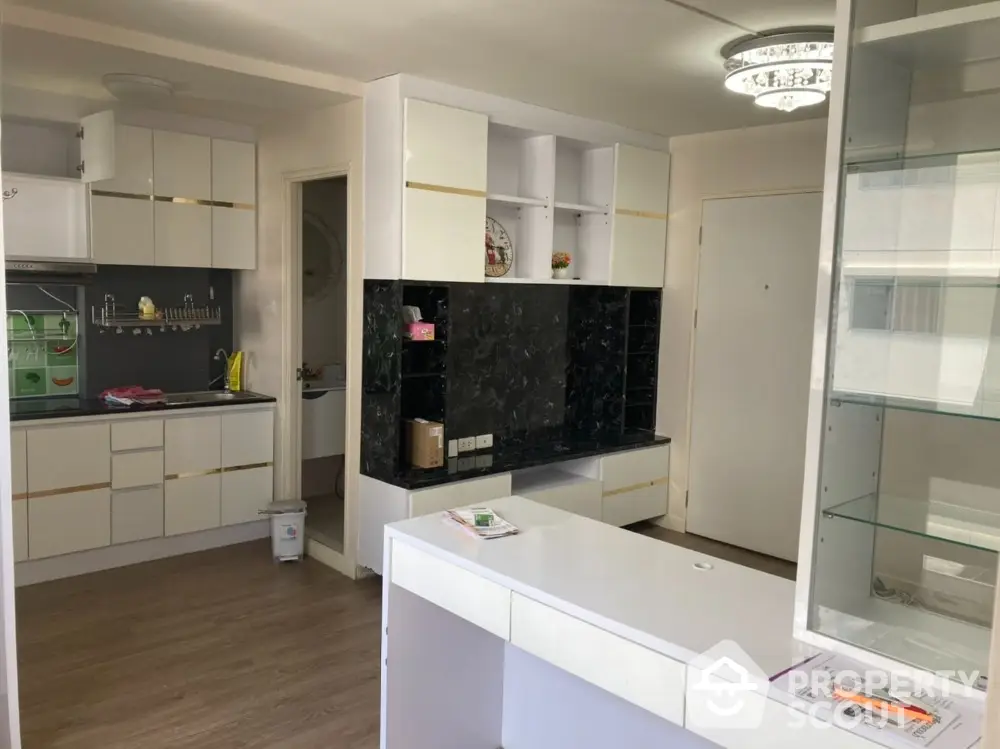 Modern kitchen with sleek cabinetry and open layout in a stylish apartment