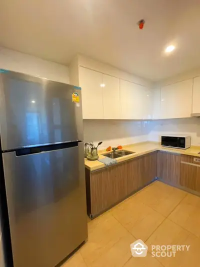 Modern kitchen with sleek appliances and stylish cabinetry in a contemporary home.