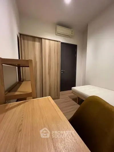 Cozy minimalist bedroom with wooden furniture and air conditioning