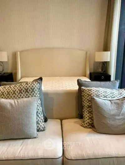 Cozy bedroom with elegant decor and plush pillows, perfect for relaxation.