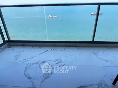 Stunning ocean view from a modern balcony with marble flooring, perfect for relaxation and enjoying the sea breeze.
