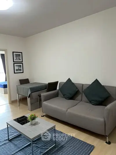 Modern living room with cozy sofa and dining area in stylish apartment.