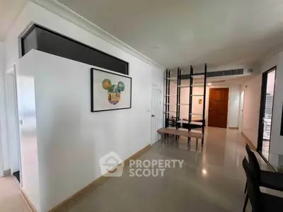 Modern interior with sleek design and open layout, featuring stylish artwork and contemporary furniture.