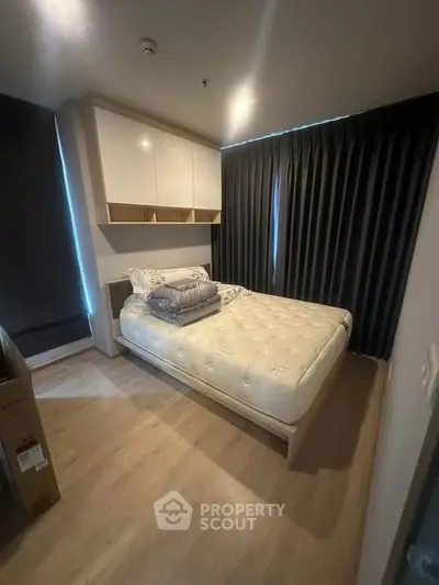 Cozy modern bedroom with stylish decor and ample natural light