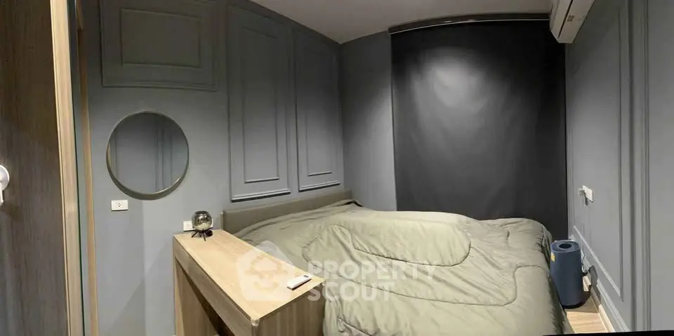 Cozy modern bedroom with sleek gray walls and minimalist decor