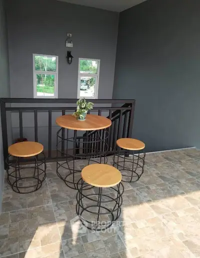 Chic balcony with modern seating and stylish tile flooring, perfect for relaxation.