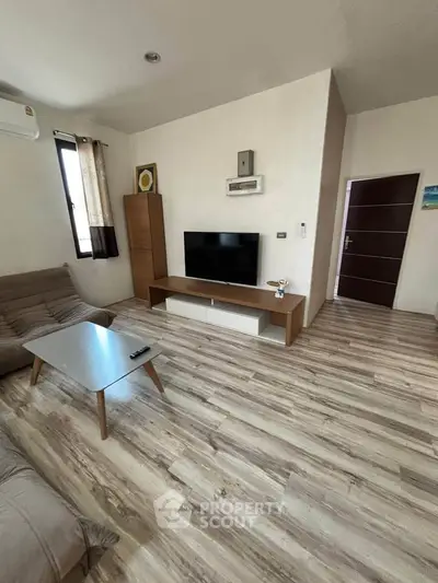 Modern living room with sleek furniture and wooden flooring