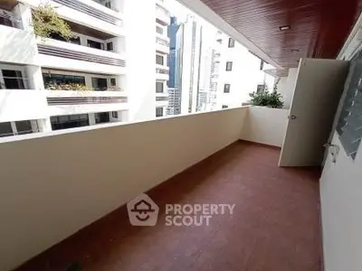 Spacious balcony with city view in modern apartment building