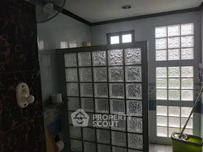 Modern bathroom with glass block wall and natural light