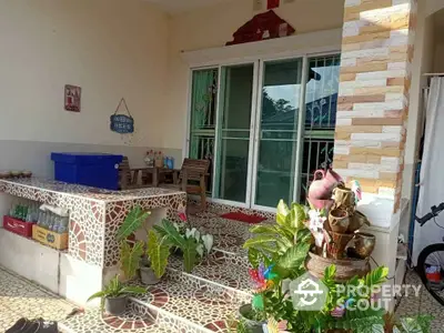 Charming home entrance with decorative tiles and lush plants