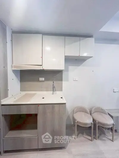 Modern compact kitchen with sleek cabinets and minimalist design