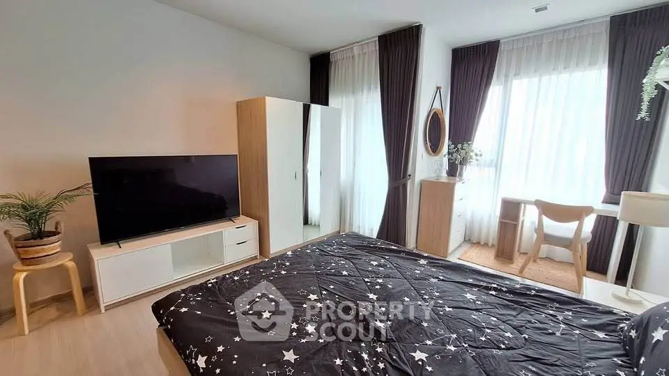 Modern bedroom with stylish decor and large windows for natural light.