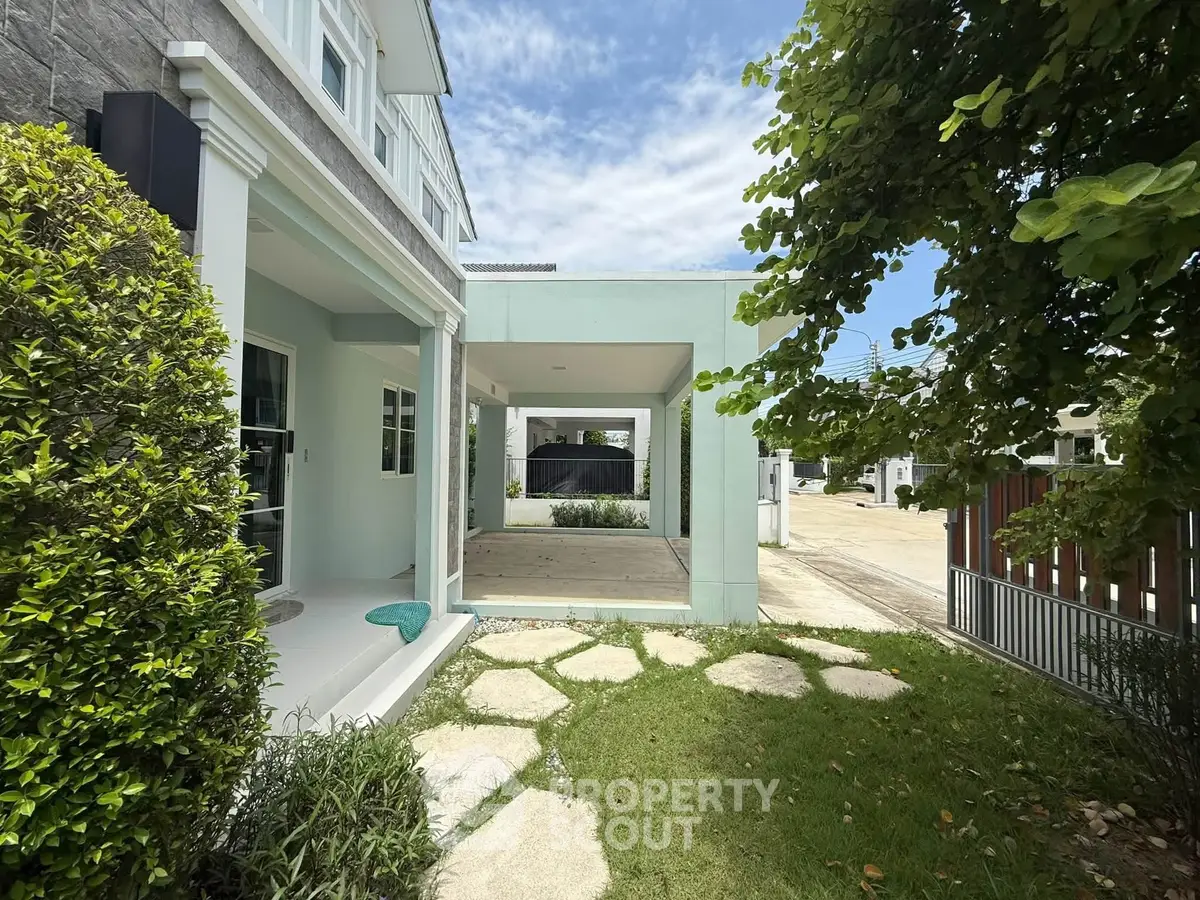 Charming suburban home with spacious garden and covered patio, perfect for outdoor relaxation.