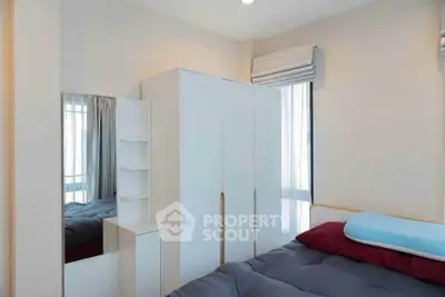 Cozy bedroom with modern wardrobe and large window for natural light